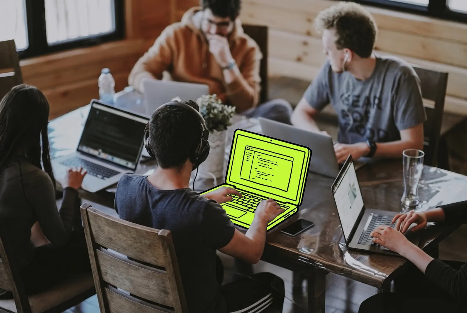 A marketing team at work, one laptop drawn in lime ink